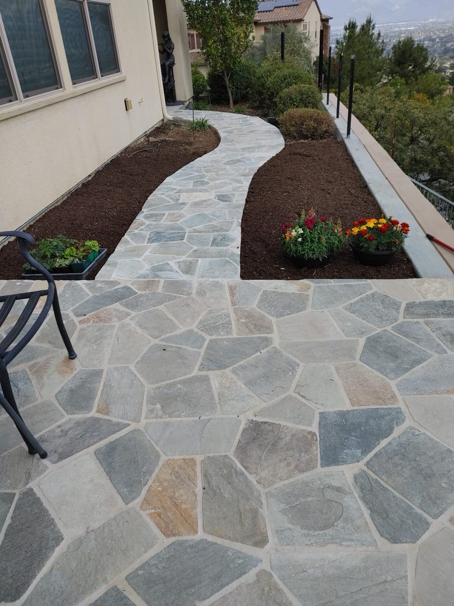 Flagstone backyard with patio and walkway.